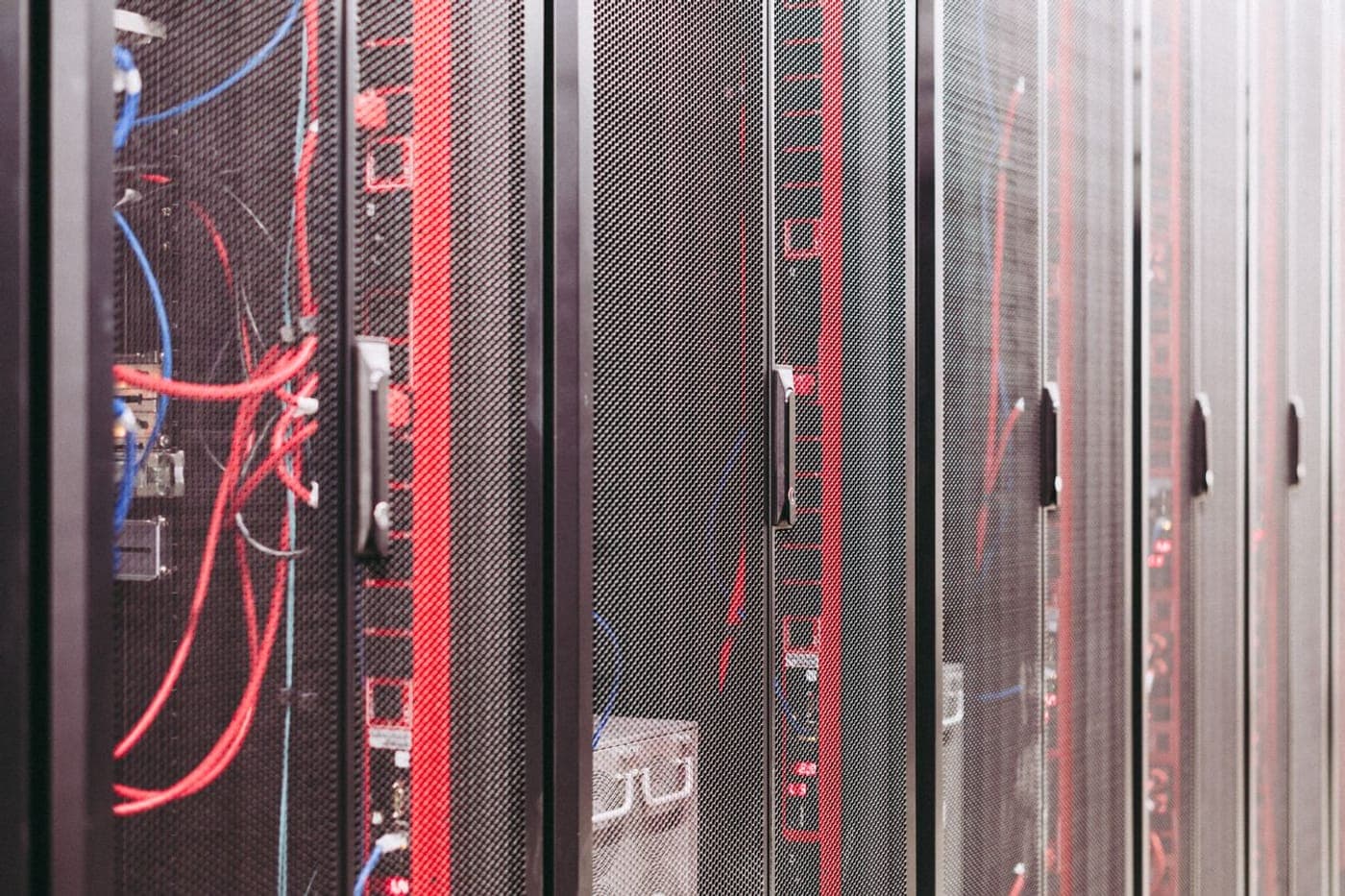 Server racks with red and blue network cables