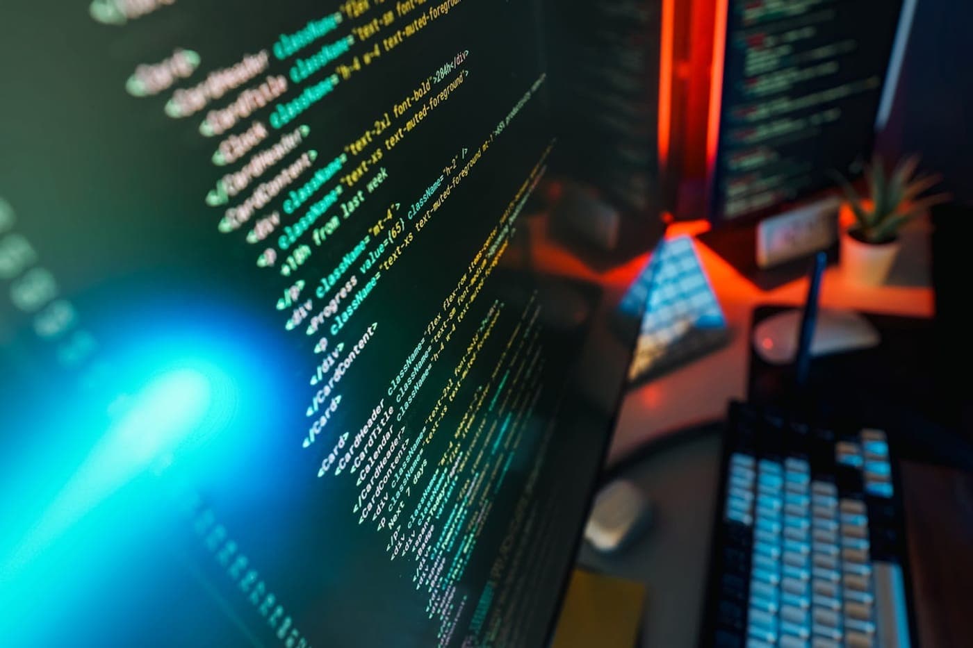 A monitor displaying source code at a tidy developer workspace