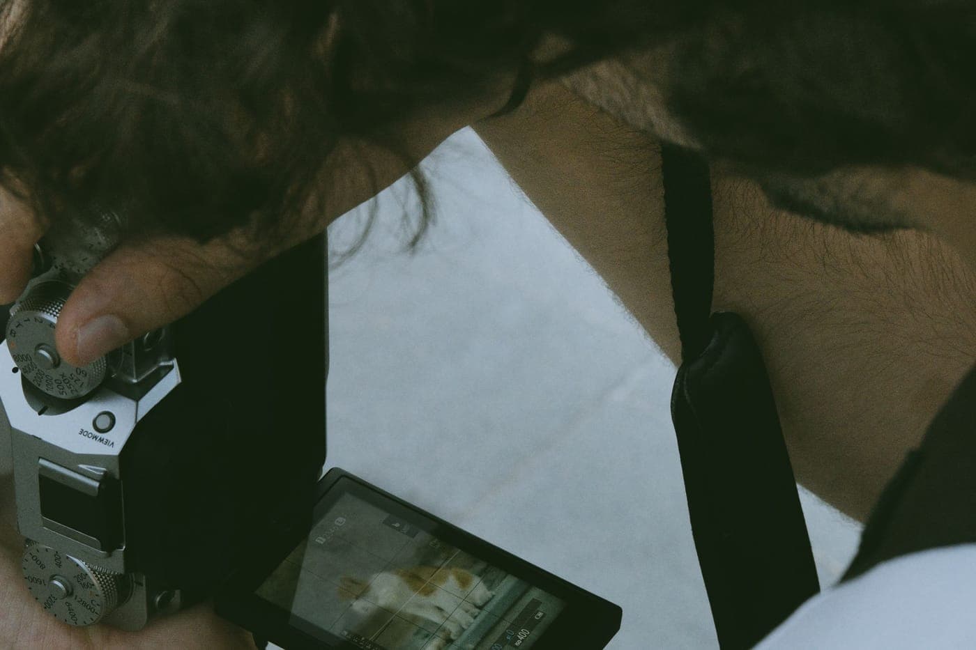 A photographer reviewing a captured image on a camera's screen