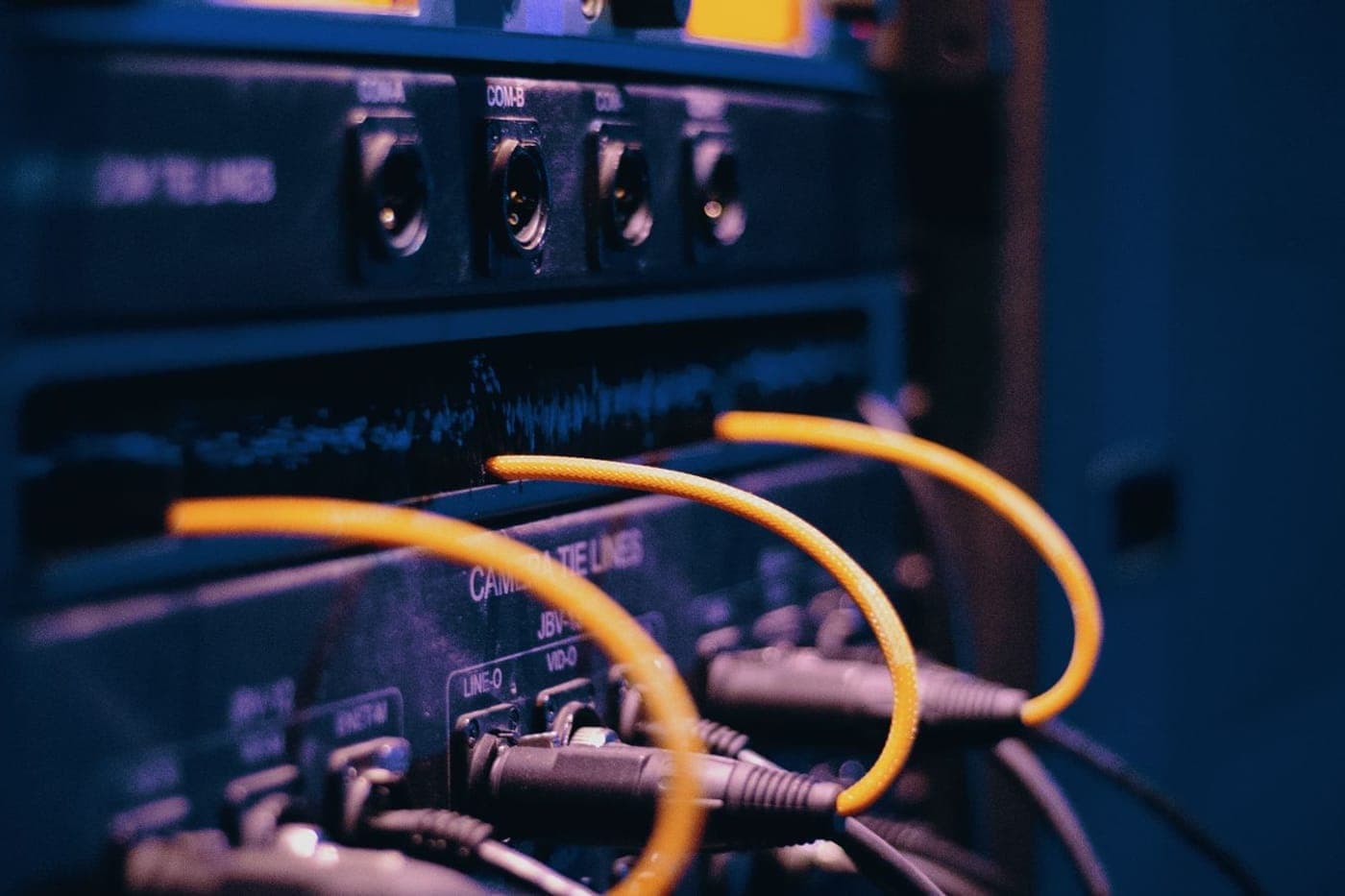Dense teal fiber patch panel with neatly bundled network cables
