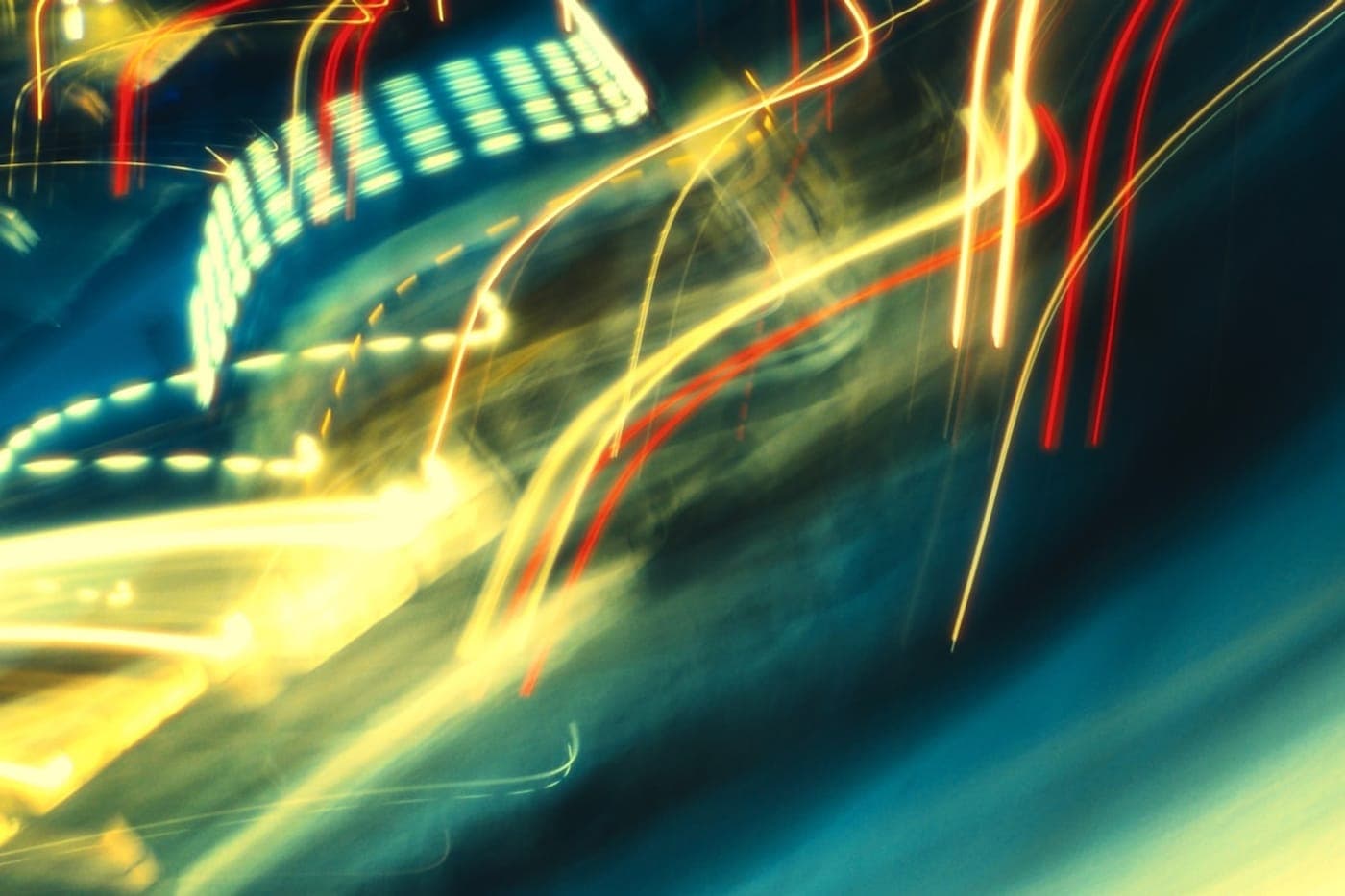 Long-exposure light trails of yellow and red streaking through the night