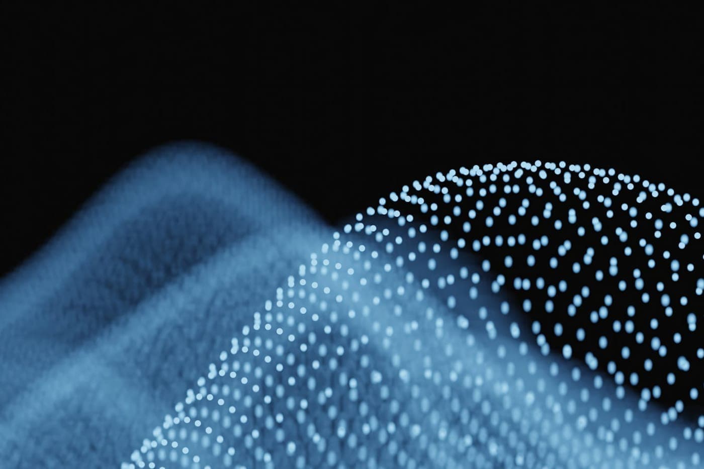Abstract blue glowing data points forming a flowing particle landscape on a black background