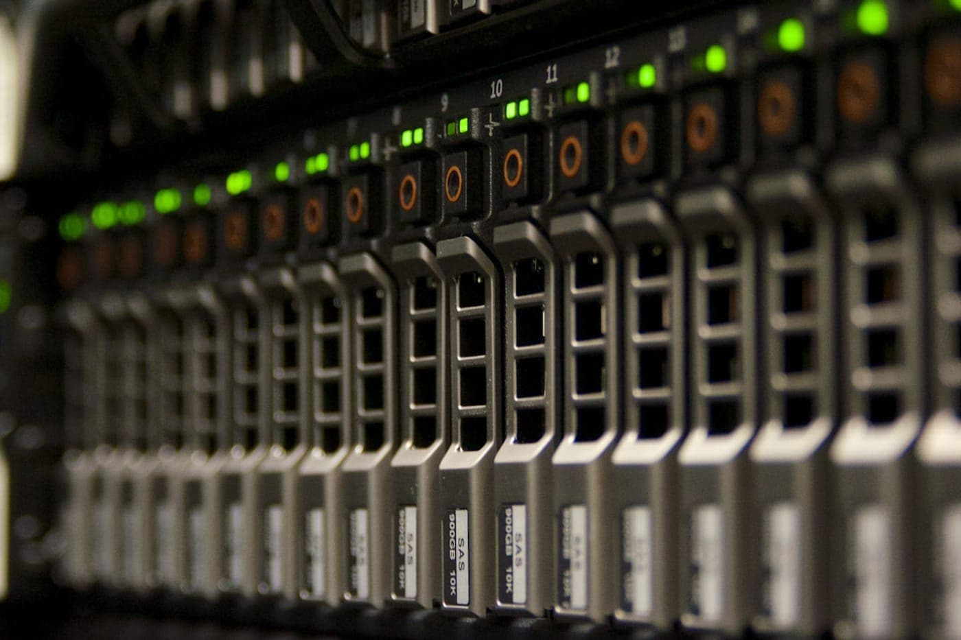 A server rack of drive bays with rows of green status lights
