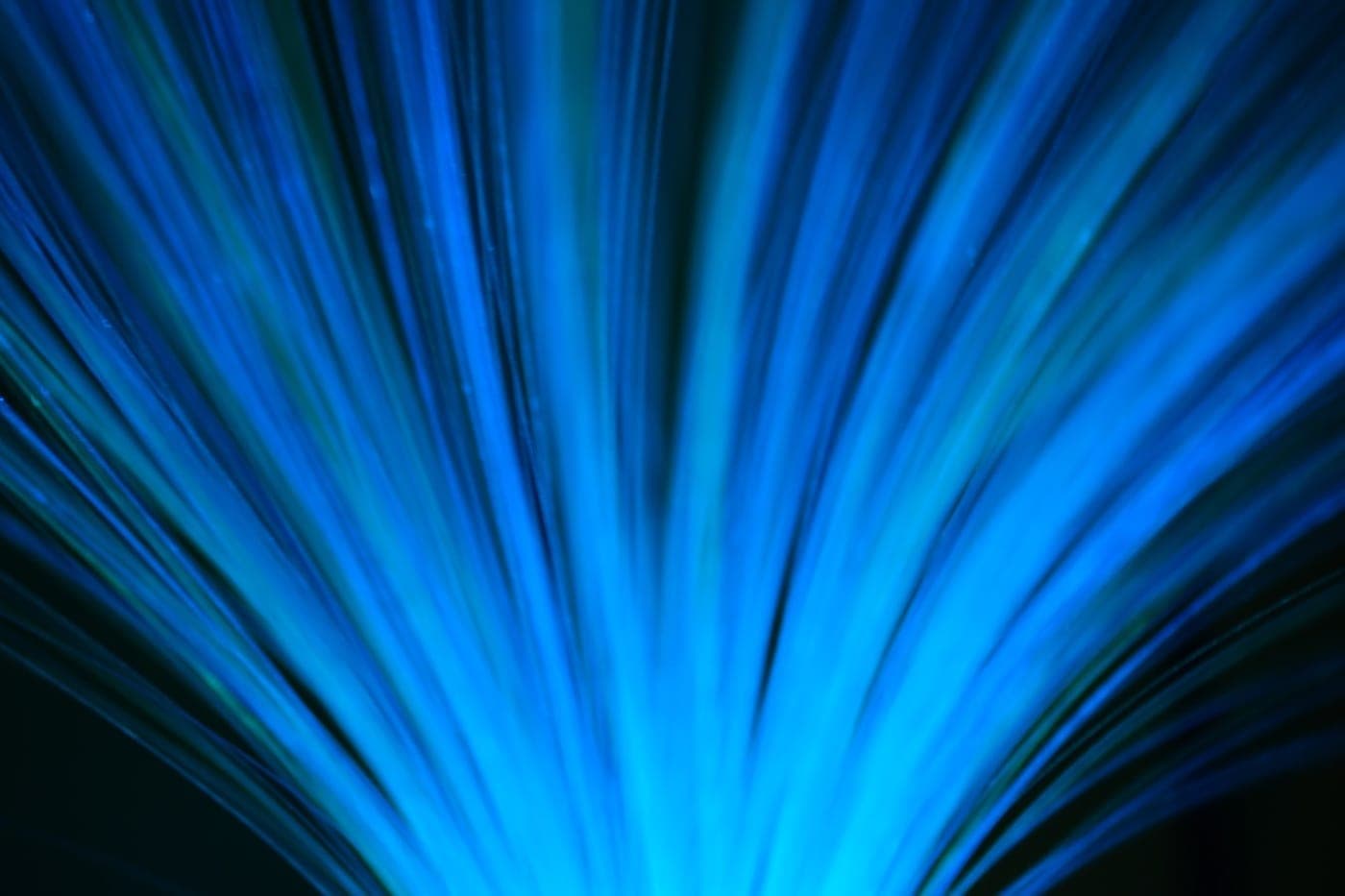 Blue fiber-optic light strands radiating outward against a dark background